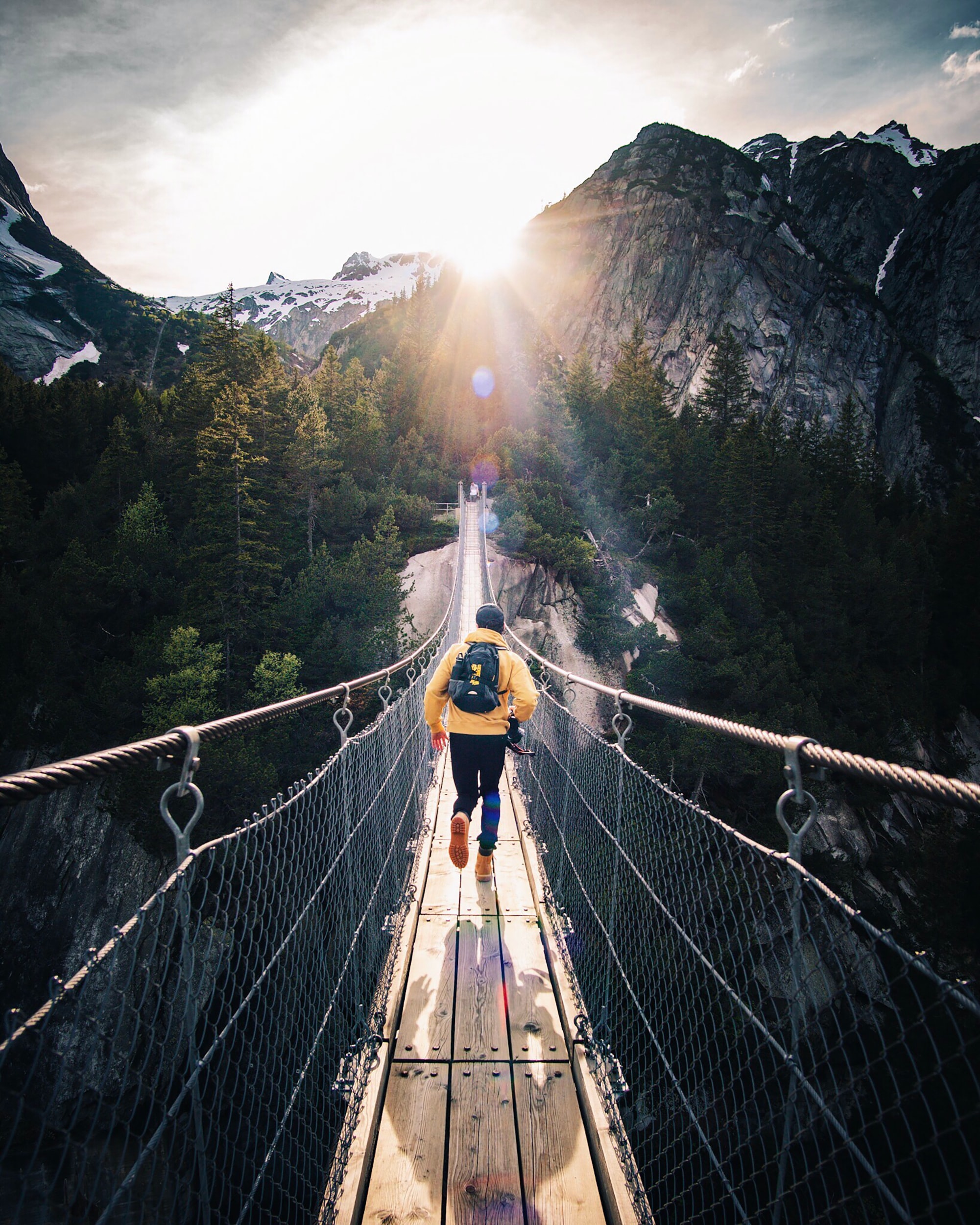 Man Walking on a Hanging Bridge