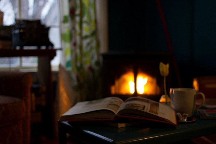 Open Book on a Table in a Room with a Fire Place